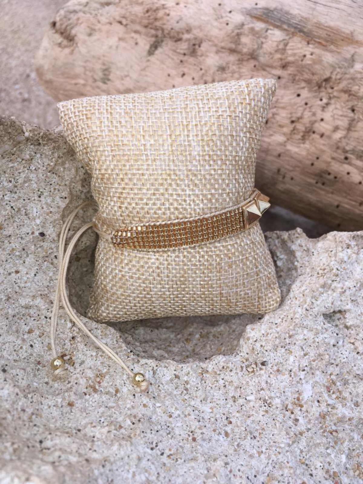 Adjustable gold beaded Bracelet with metal details.